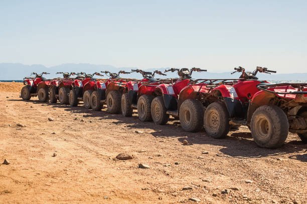 Red quads stand in a row on the shore of the Red Sea. Dahab, Egypt. Holiday and adventure concept