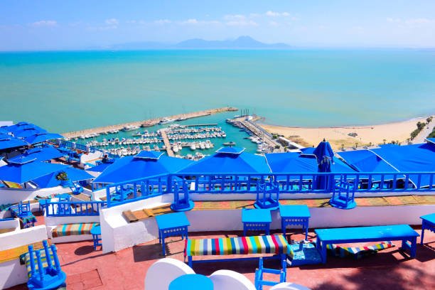 istockphoto-1140466418-612x612 Tunisia - Sidi Bou Said quaint village terrace. View over marina and Mediterranean Sea. Whitewashed walls and traditional blue wooden benches.
